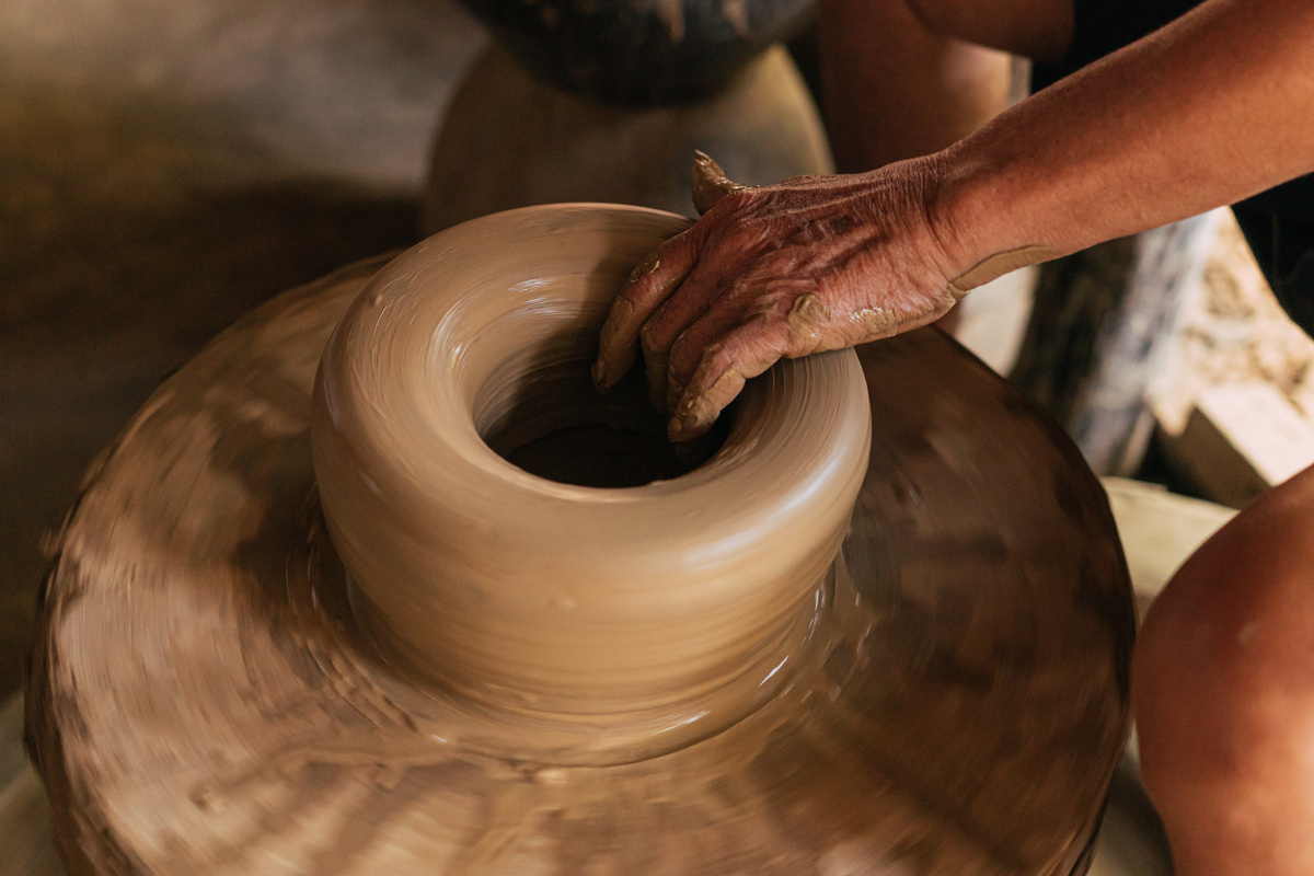 Person Making a Clay Jar